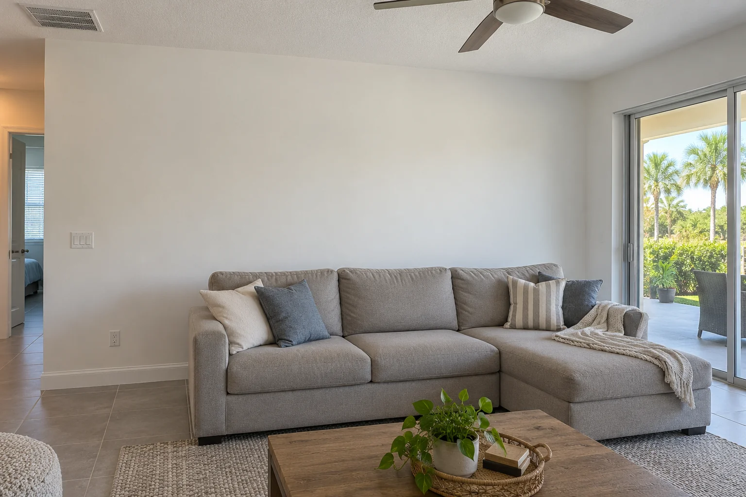 Repaired painted great room wall behind a sofa.