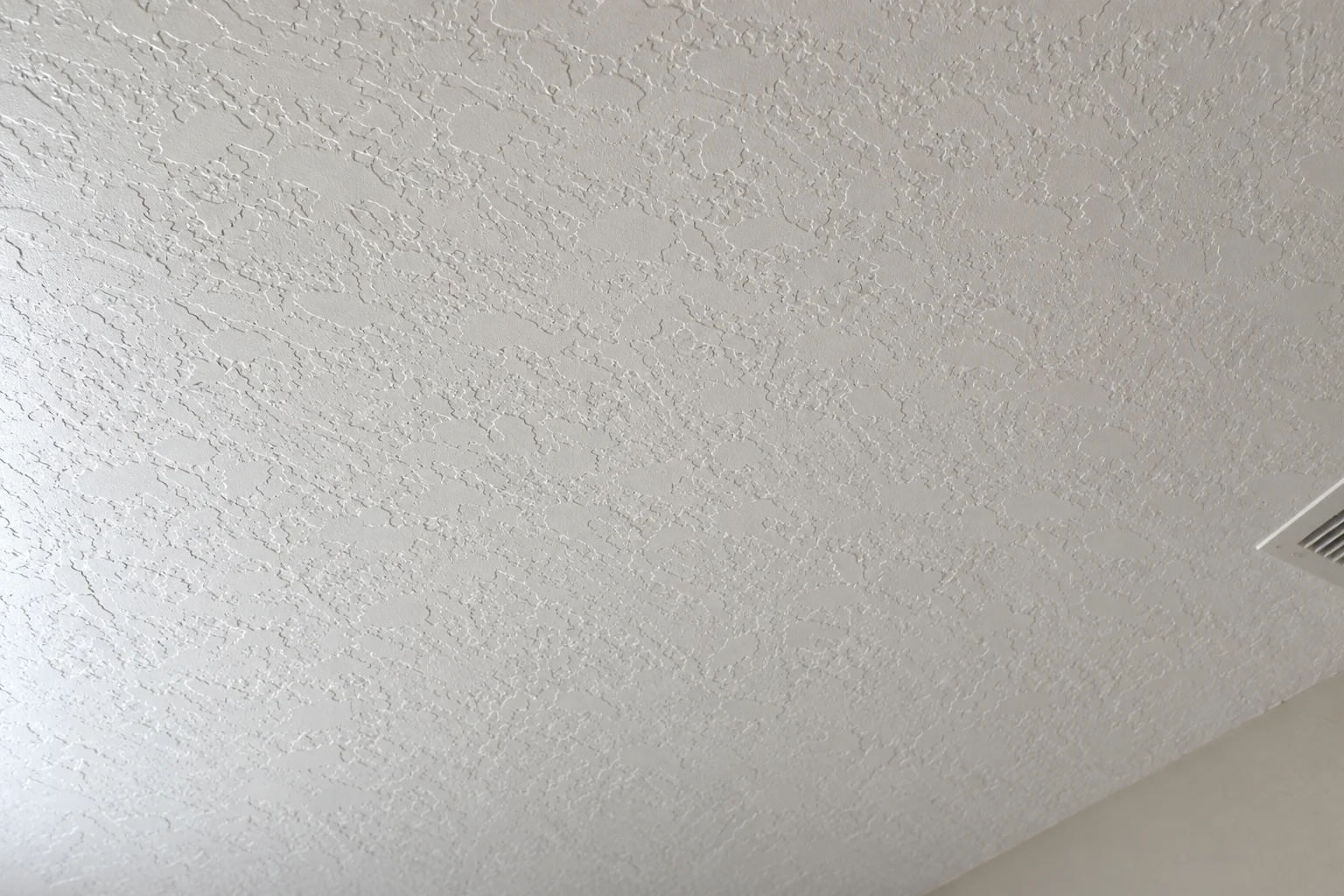 White ceiling with an even knockdown texture across the repaired area.